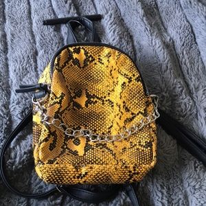 A scaly snake bag with a silver chain